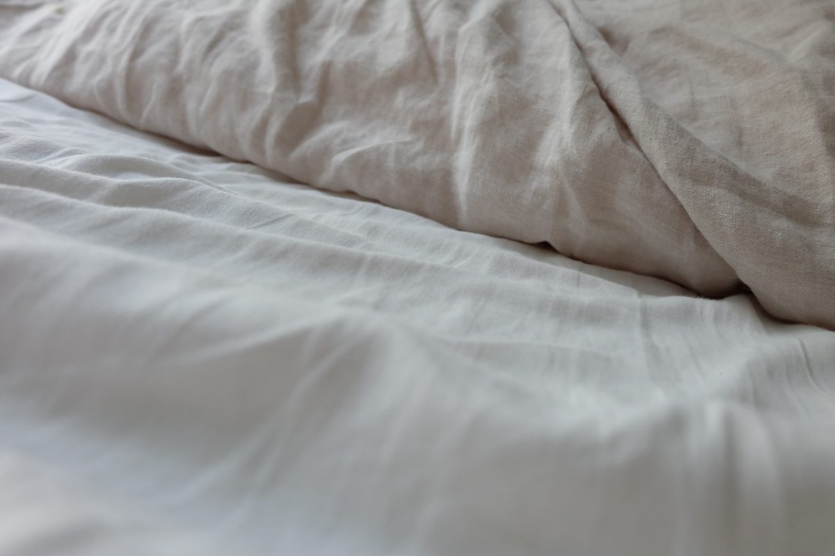 Cheap sheets are so cheap if you have to keep replacing them. Linen is almost impossible to beat if you are looking for fabric that can keep you comfortable and last a lifetime.   (HanneLink/Shutterstock)