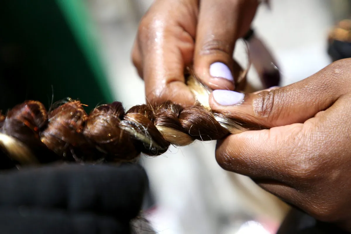 A guest has her hair braided at the Los Angeles Convention Center in Calif. on June 21, 2019. (Robin L Marshall/Getty Images for BET)