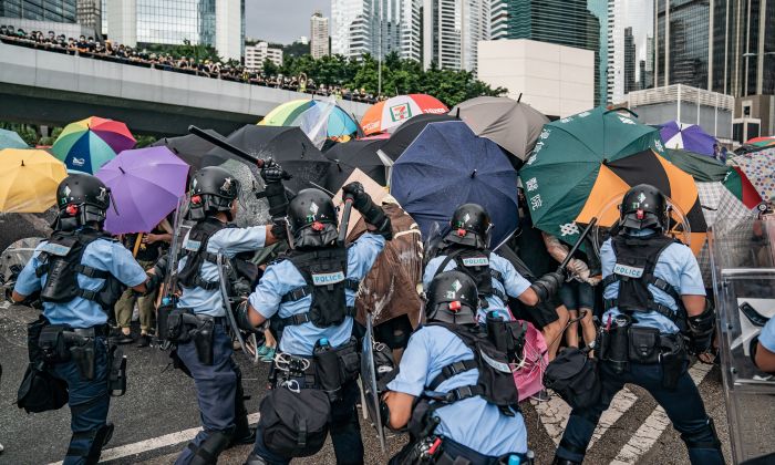 Police officers use baton to disperse anti-extradition protesters during a clash outside the Legislative Council Complex on July 1, 2019 in Hong Kong, China. (Anthony Kwan/Getty Images)
