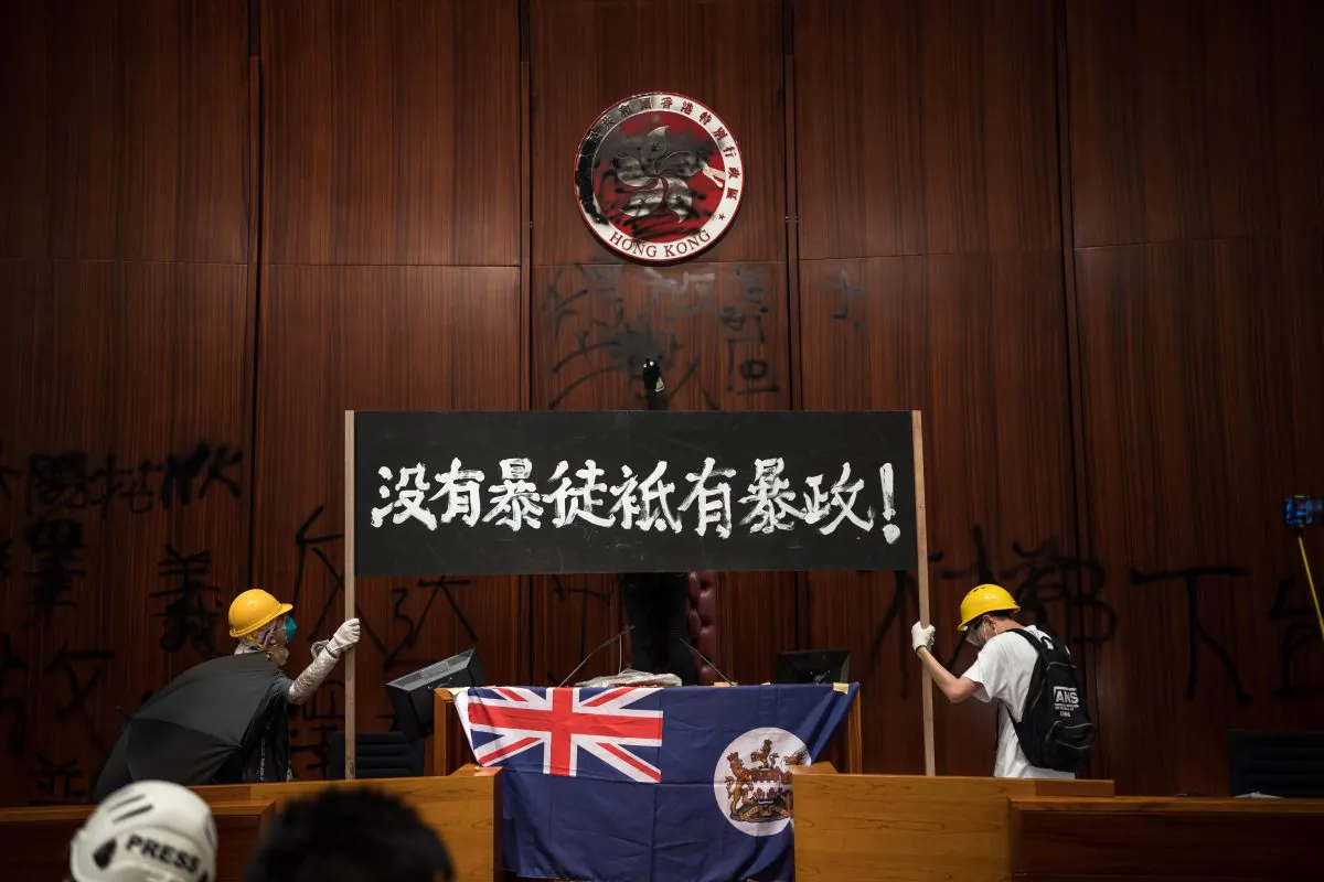 Protesters hold a banner with the words “No Rioters, Only Tyranny” at the Legislative Council to protest against the extradition bill in Hong Kong on July 1, 2019. (Billy H.C. Kwok/Getty Images)