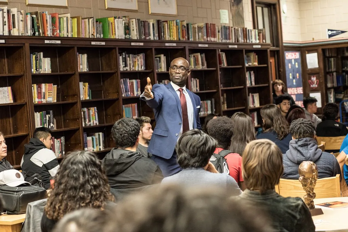 Sunny Akhigbe speaking with a group of young people. (Courtesy of A Boy and His Dream Foundation)