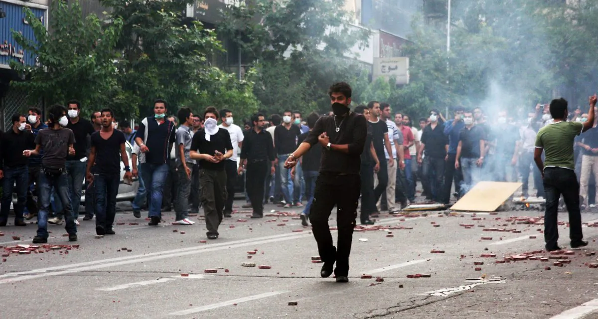 Supporters of Iran's defeated presidential candidate Mir Hossein Mousavi clash with police (unseen) during a protest in Tehran on June 20, 2009. (NARGES TANKBRIS/AFP/Getty Images)