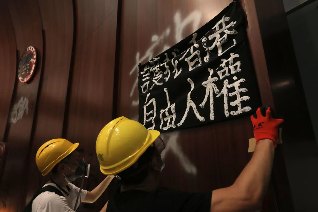 Protesters put up a sign reading "Protect my Hong Kong; Freedom, human rights," after breaking into the parliament chambers of the government headquarters in Hong Kong on July 1, 2019. (VIVEK PRAKASH/AFP/Getty Images)