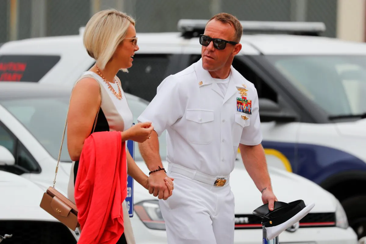 U.S. Navy SEAL Special Operations Chief Edward Gallagher arrives at court with his wife Andrea for the start of his court-martial trial at Naval Base San Diego in San Diego, Calif., on June 18, 2019.  (Mike Blake/Reuters)