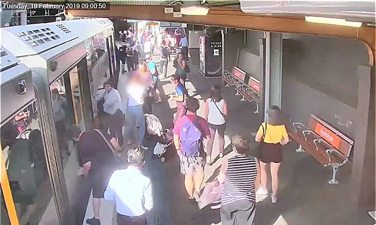 People look down between a train and platform, as a boy fell through train gap, in Sydney, Australia on Feb. 19, 2019, in this video grab obtained by Reuters on July 2, 2019. (SYDNEY TRAINS/via Reuters)