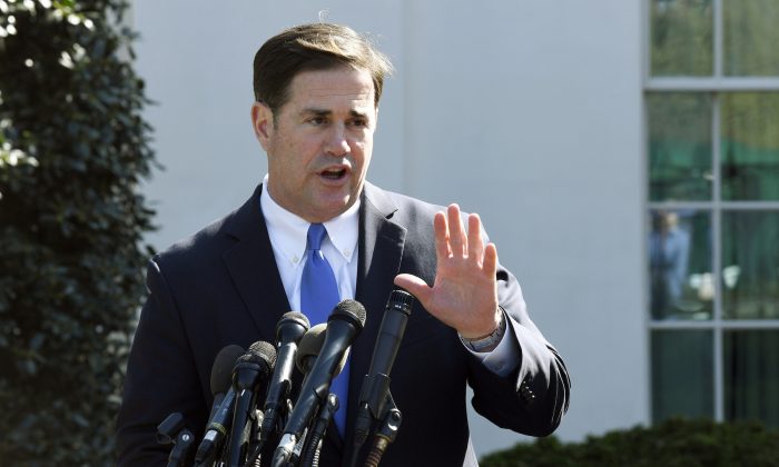 Arizona Gov. Doug Ducey talks to reporters outside the West Wing of the White House in Washington on April 3, 2019. (AP Photo/Susan Walsh, File)