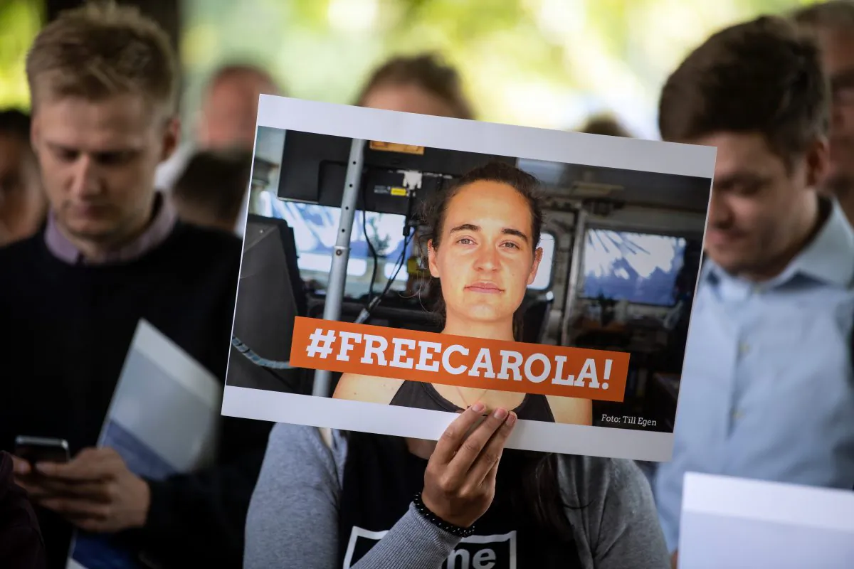 TOPSHOT - Demonstrators hold a banner reading "Free Carola" during a vigil on July 2, 2019 in Cologne, western Germany (Photo by Federico Gambarini / dpa / AFP) / Germany OUT        (GAMBARINI/AFP/Getty Images)