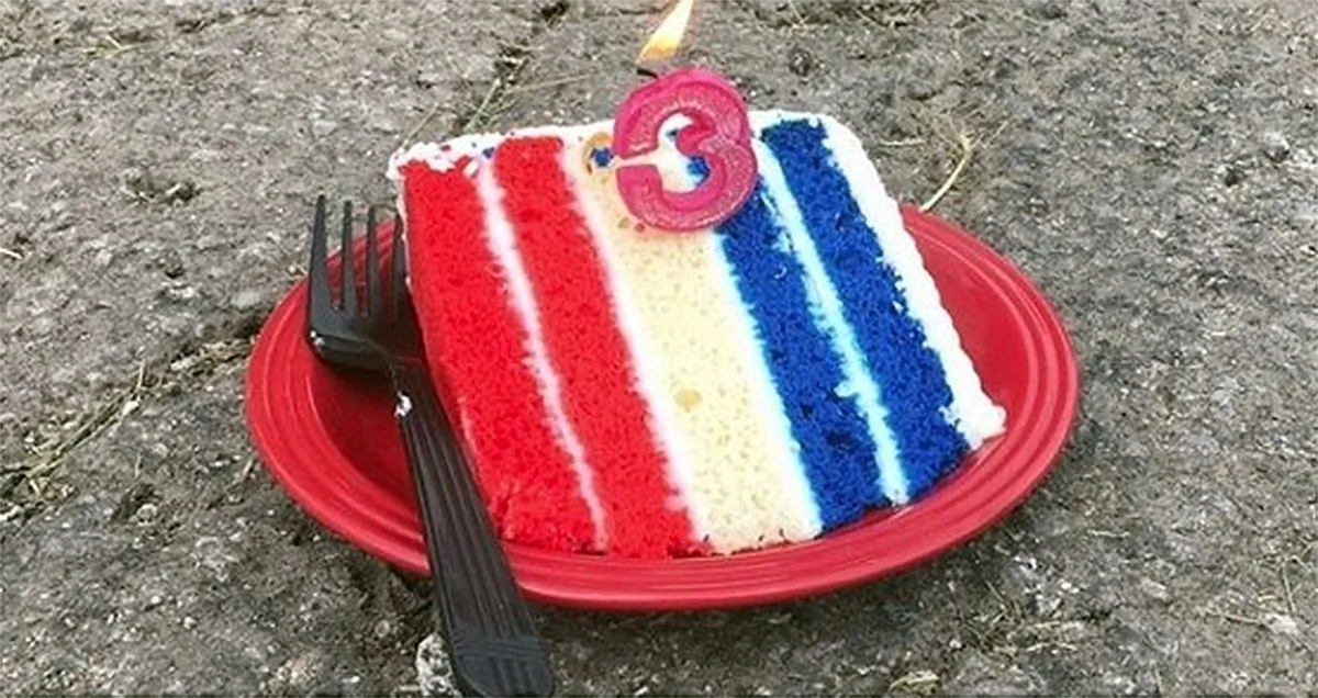 A slice of cake with a candle to celebrate a pothole's third month birthday in Kansas City, Mo., on July 2, 2019. (Frank Sereno/Facebook)