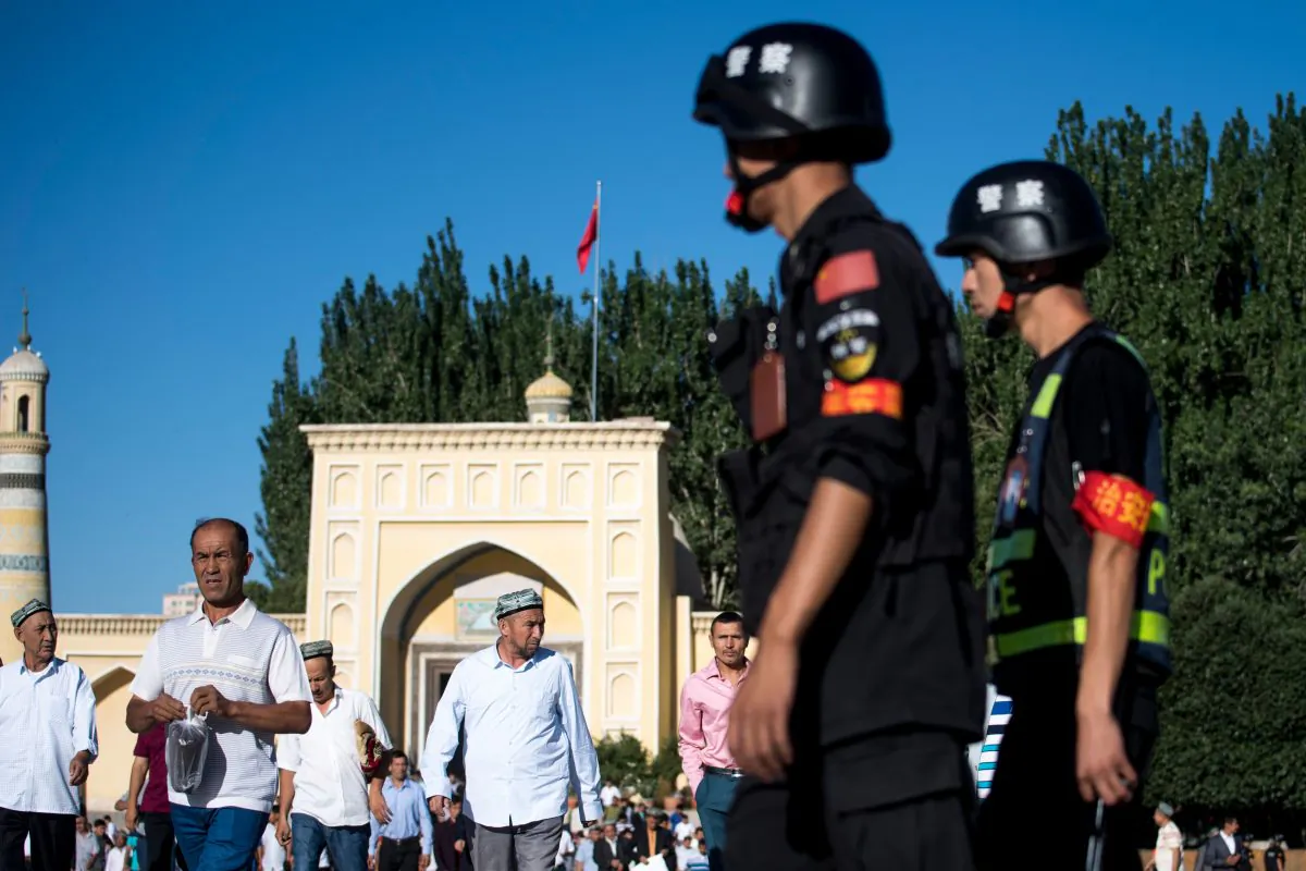 Police patrolling as Muslims leave the Id Kah Mosque after the morning prayer on Eid al-Fitr in Kashgar, Xinjiang, China, on June 26, 2017.
(Johannes Eisele/AFP/Getty Images)