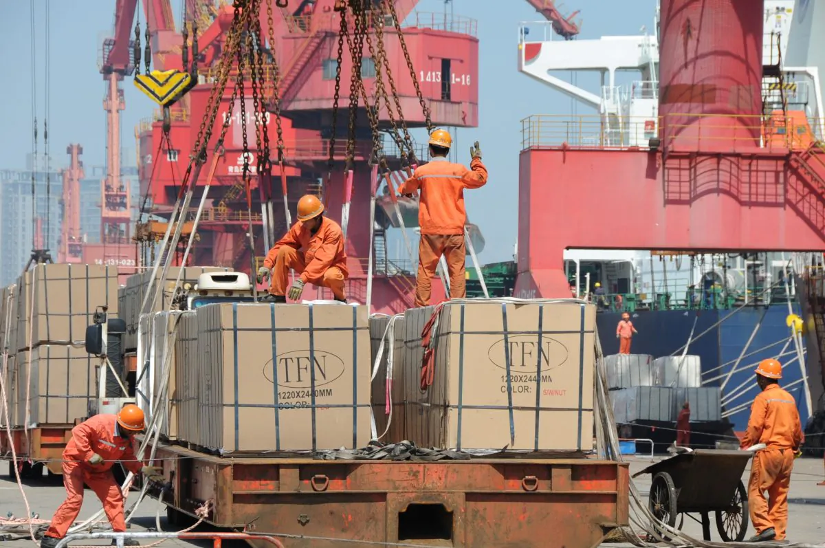 Workers load goods for export onto a crane at a port in Lianyungang City, Jiangsu Province, China, on June 7, 2019. (REUTERS/Stringer)
