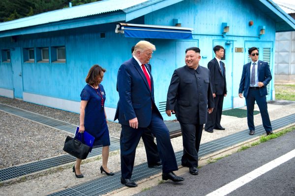Donald Trump and Kim Jong Un walk in the demilitarized zone