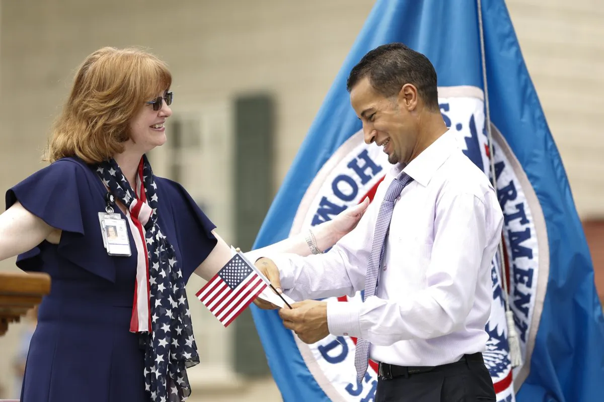 Kimberly Zanotti, USCIS Washington field office director congratulates a new U.S. citizen during Naturalization Ceremony at Mount Vernon, Va., on July 4, 2019. (Samira Bouaou/The Epoch Times)