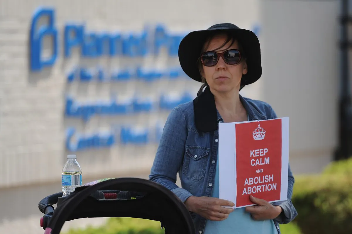 A woman displays a sign in support of abortion legislation during a pro-life rally outside the Planned Parenthood Reproductive Health Center in St Louis, Mo., on June 4, 2019.  Michael B. Thomas/Getty Images
