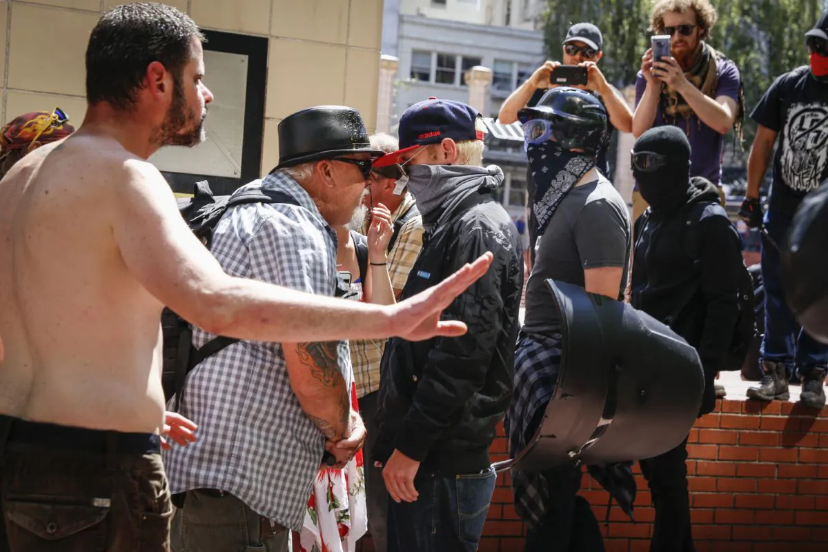 A man who was later assaulted by Antifa, second from left, faces off with Rose City Antifa members at Pioneer Courthouse Square in Portland, Ore., on June 29, 2019. (Moriah Ratner/Getty Images)
