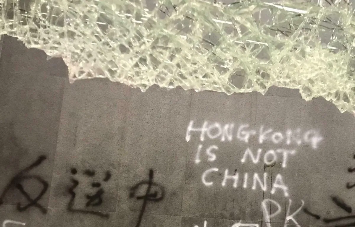 Damage to the Legislative Council following a break-in by protesters is seen during a media tour in Hong Kong on July 3, 2019. Chinese characters read "No Extradition to China." (Johnson Lai/AP)