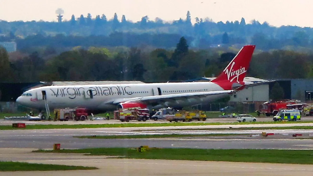 A Virgin Atlantic aircraft stands on the tarmac with emergency service vehicles after making an emergency landing at Gatwick Airport in London, England, on April 16, 2012. (Scott Heavey/File Photo via Getty Images)