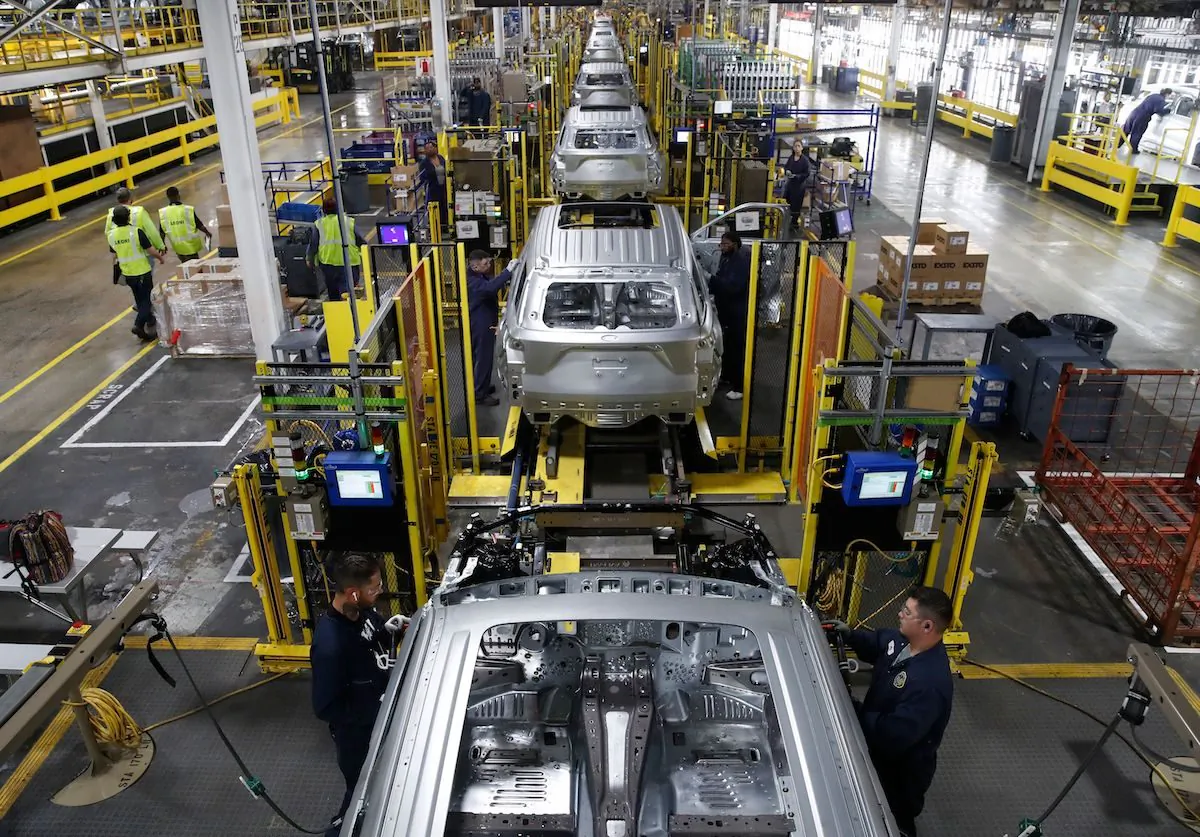 Workers assemble cars at the newly renovated Ford's Assembly Plant in Chicago, on June 24, 2019. (Jim Young/AFP/Getty Images)