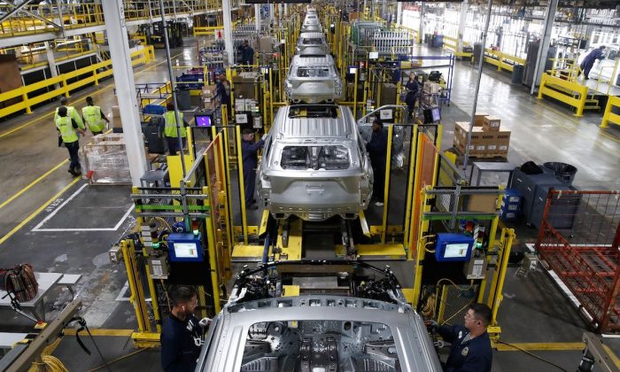 Workers assemble cars at the newly renovated Ford's Assembly Plant in Chicago, on June 24, 2019. (Jim Young/AFP/Getty Images)
