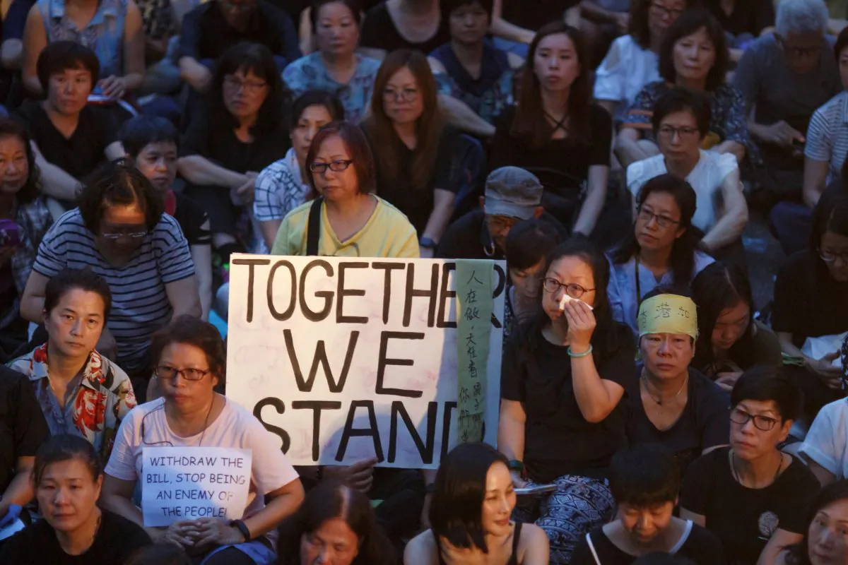 People hold placards during a gathering of Hong Kong mothers to show their support for the city's young pro-democracy protesters in Hong Kong, China on July 5, 2019. (Thomas Peter/Reuters)