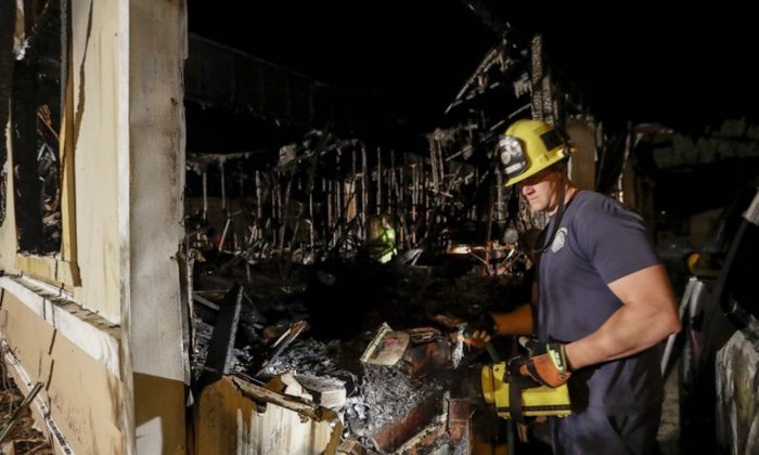 A fireman looks over a home that burned after an earthquake in Ridgecrest, Calif., on July 6, 2019. (Marcio Jose Sanchez/AP Photo)