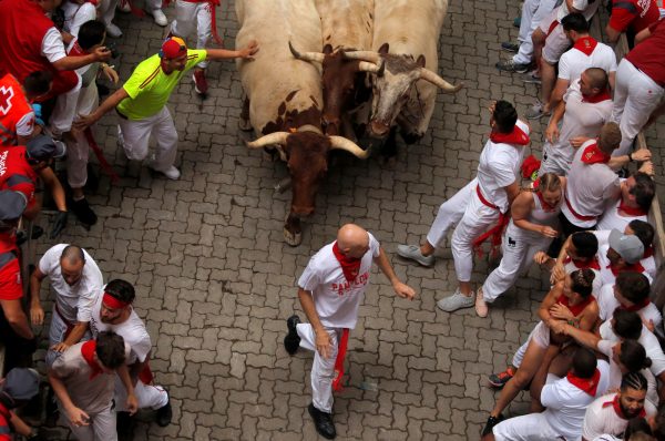 people running away from bulls