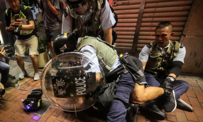 A protester reacts as he is detained during clashes with the police in Mong Kok district after a demonstration at West Kowloon railway station protesting against the proposed extradition bill on July 7, 2019, in Hong Kong. (VIVEK PRAKASH/AFP/Getty Images)