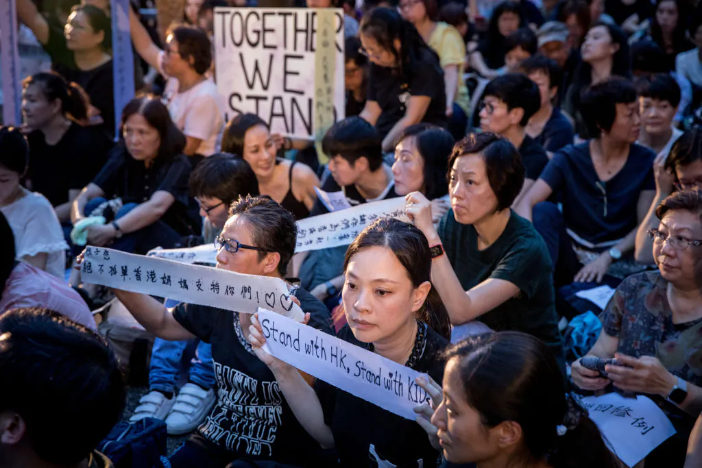 People hold up banners and posters during a "mums protest" against alleged police brutality and the proposed extradition treaty in Hong Kong on June 5, 2019. (Chris McGrath/Getty Images)