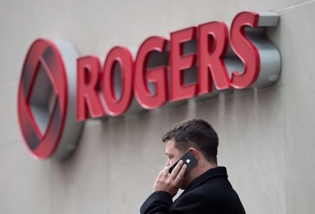 A man speaks on a mobile phone outside Rogers Communications Inc.'s annual general meeting of shareholders in Toronto on April 22, 2014. (Darren Calabrese/The Canadian Press)
