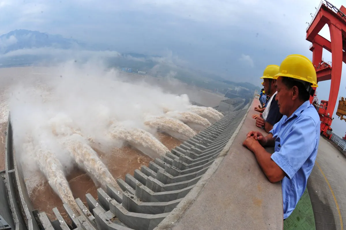 Workers watch the water released from the Three Gorges Dam, a gigantic hydropower project on the Yangtze River in Yichang, central China's Hubei Province on July 24, 2012. (STR/AFP/GettyImages)