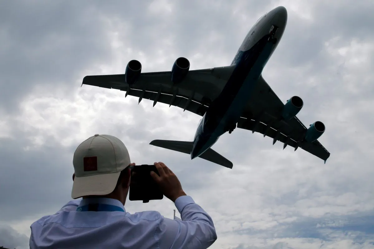 A visitor takes a picture of an Airbus A380 as it lands after an air display at the 53rd International Paris Air Show at Le Bourget Airport near Paris, France on June 23, 2019. (Pascal Rossignol/Reuters)
