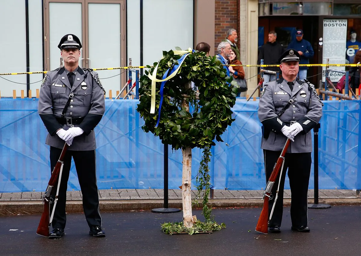 Massachusetts state and local police and fire department members commemorate the one-year anniversary of the Boston Marathon bombings on April 15, 2014. On July 8, a young man inspired by the Marathon bombings plead guilty to attempting to assist ISIS. (Jared Wickerham/Getty Images)