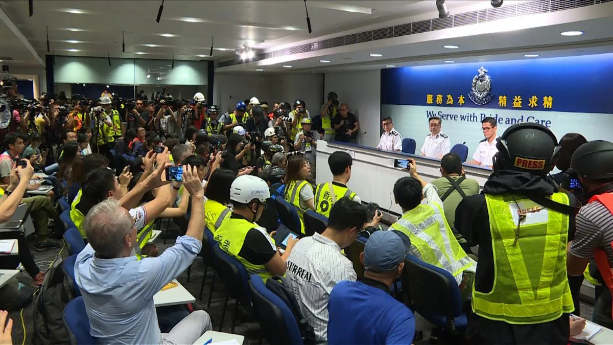 Hong Kong journalists dress in high visibility jackets and helmets at a police presser to protest excessive force used against them during the June 12 clashes between police and protesters against a controversial extradition bill, in Hong Kong on June 13, 2019. (AFPTV TEAM/AFP/Getty Images)