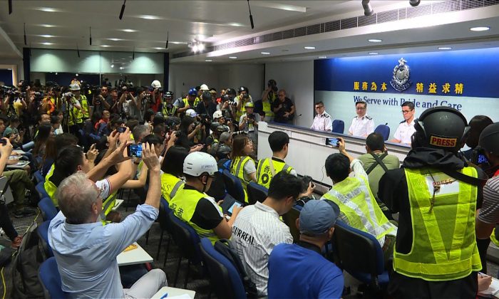 Hong Kong journalists dress in high visibility jackets and helmets at a police presser to protest excessive force used against them during the June 12 clashes between police and protesters against a controversial extradition bill, in Hong Kong on June 13, 2019. (AFPTV TEAM/AFP/Getty Images)