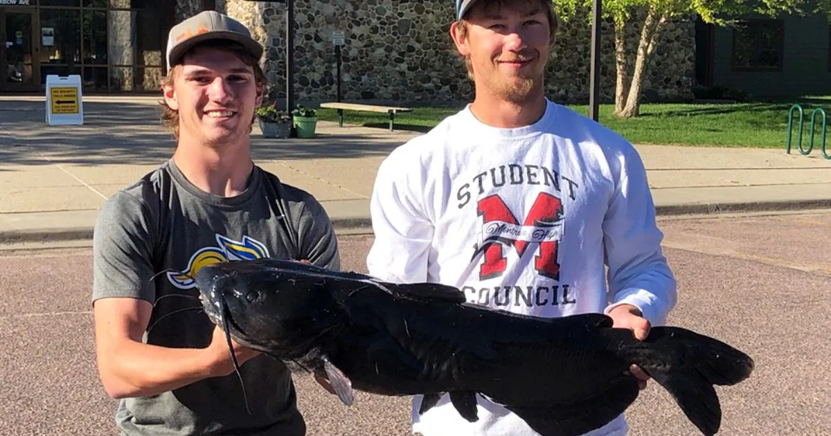 Fishing enthusiasts Cody Sechser (L) and Isaac Kipp caught this record-breaking catfish in Skunk Creek, South Dakota, on June 9, 2019. (South Dakota Game, Fish and Parks/Facebook)