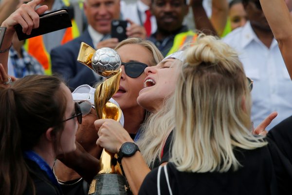 U.S. women soccer players celebrate as they arrive at the Newark International Airport with the trophy for the FIFA Women's World Cup, in Newark, New Jersey