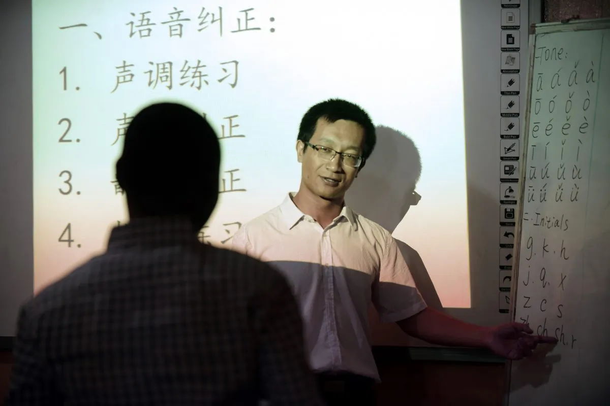 A Chinese language teacher teaches Mandarin at the Confucius Institute at the University of Lagos, Nigeria, on April 6, 2016. Intelligence agencies say Chinese regime-funded Confucius Institutes are a way for China to advance its influence in the host countries, or to be used for espionage purposes by Beijing. (Pius Utomi Ekpei/AFP/Getty Images)