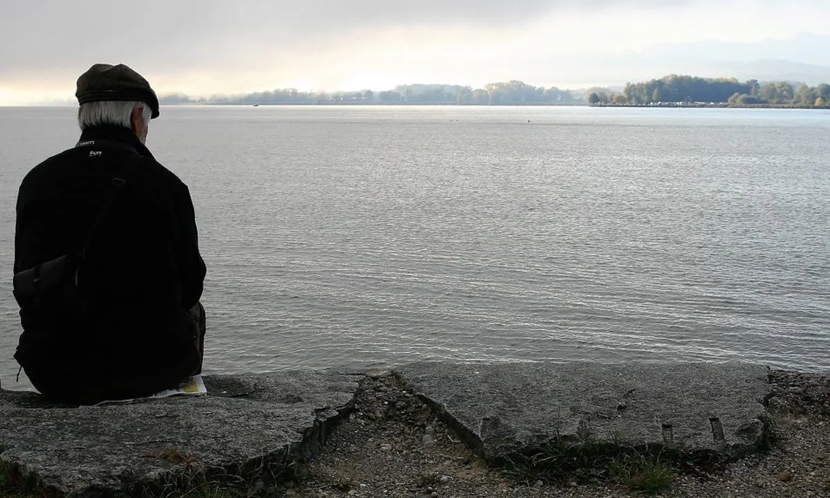 Stock image of an old man sitting by himself. (Pixabay)