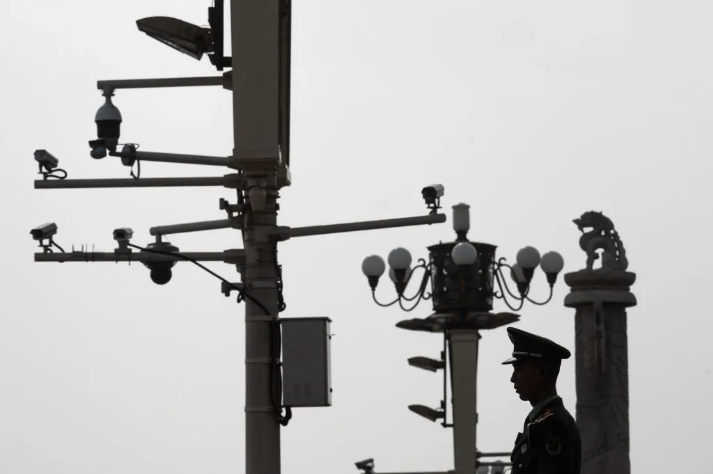 A Chinese paramilitary policeman stands guard before security cameras at Tiananmen Square in Beijing on April 8, 2019. (STR/AFP/Getty Images)