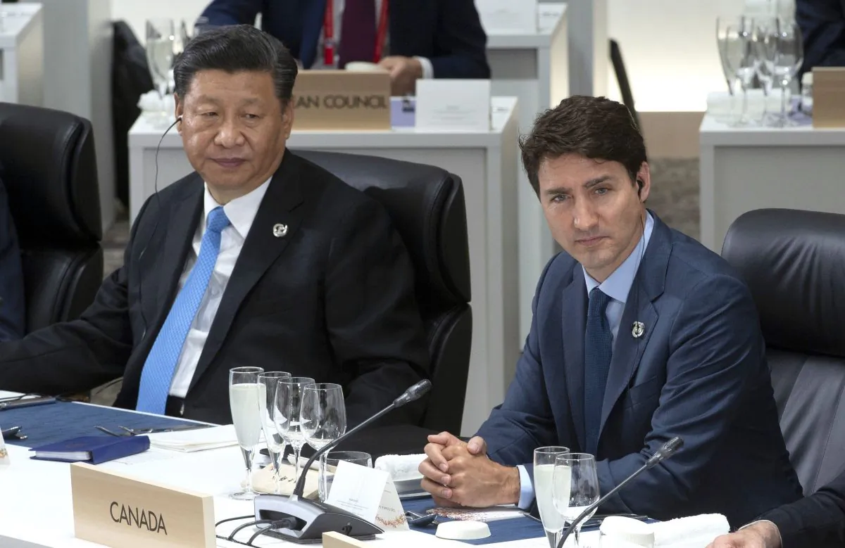 Canadian Prime Minister Justin Trudeau and Chinese President Xi Jinping listen to opening remarks at a plenary session at the G20 Summit in Osaka, Japan on Friday June 28, 2019. (The Canadian Press/Adrian Wyld)