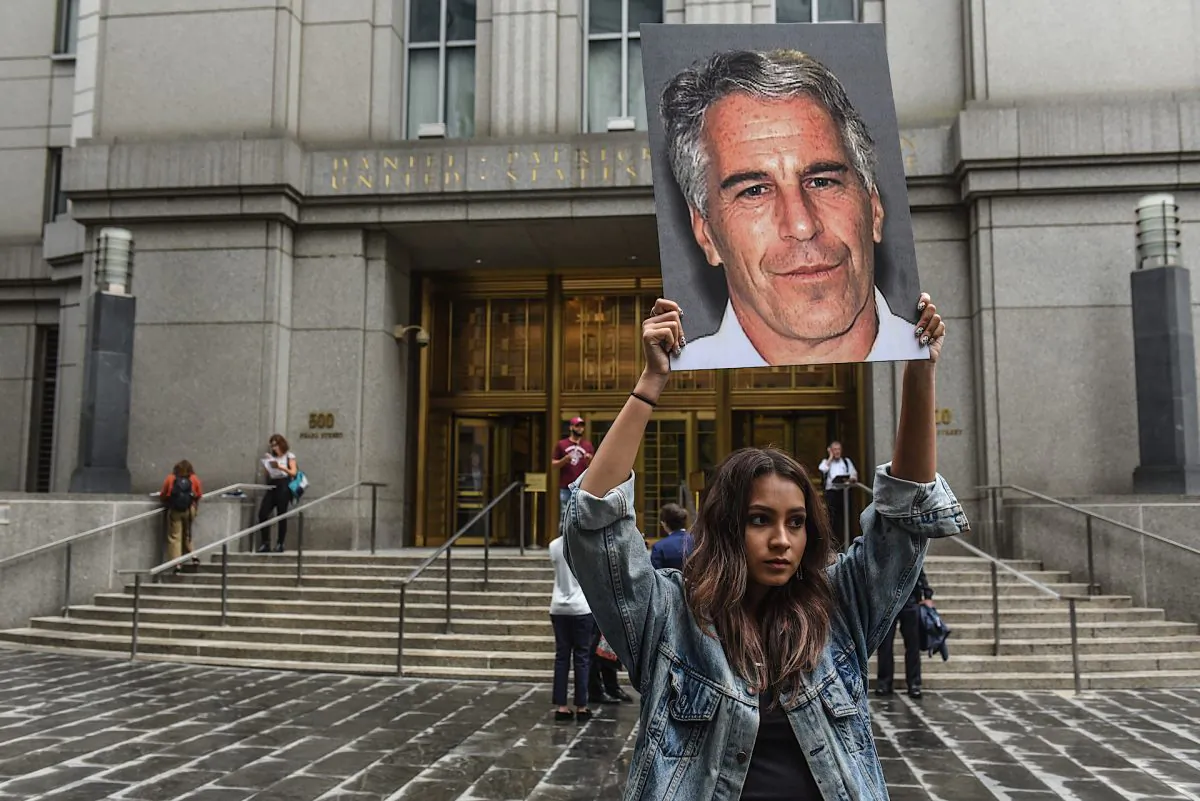 A protester holding a sign of Jeffrey Epstein in front of the federal courthouse in New York City on July 8, 2019. (Stephanie Keith/Getty Images)