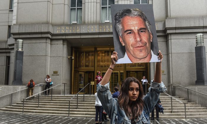 A protester holding a sign of Jeffrey Epstein in front of the federal courthouse in New York City on July 8, 2019. (Stephanie Keith/Getty Images)