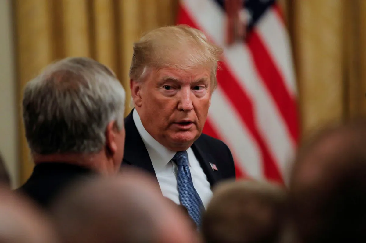 President Donald Trump talks with attendees as he departs an event held to tout his administration's environmental policies in the East Room of the White House in Washington on July 8, 2019. (Carlos Barria/Reuters)