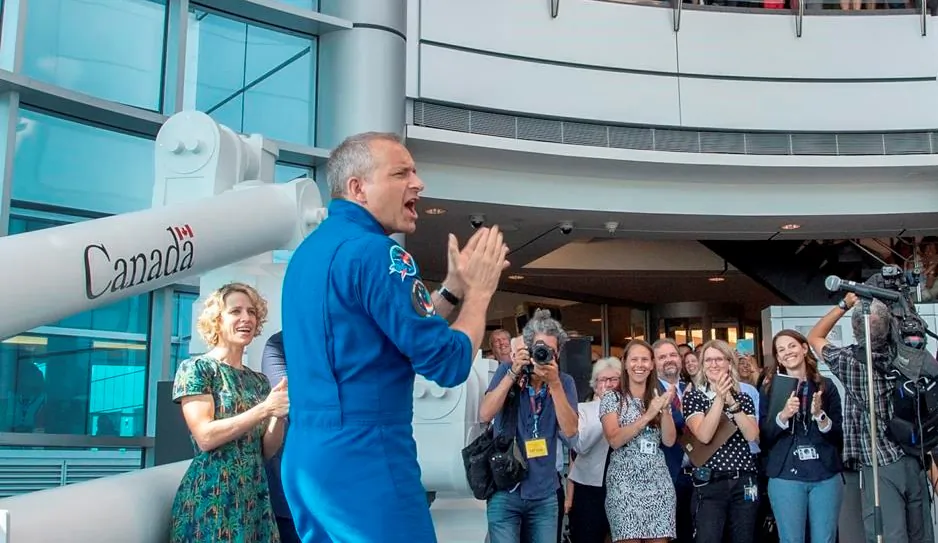 Canadian astronaut David Saint-Jacques is welcomed by colleagues on July 10, 2019 as he arrives at the Canadian Space Agency headquarters in St. Hubert, Quebec. (Ryan Remiorz/The Canadian Press)