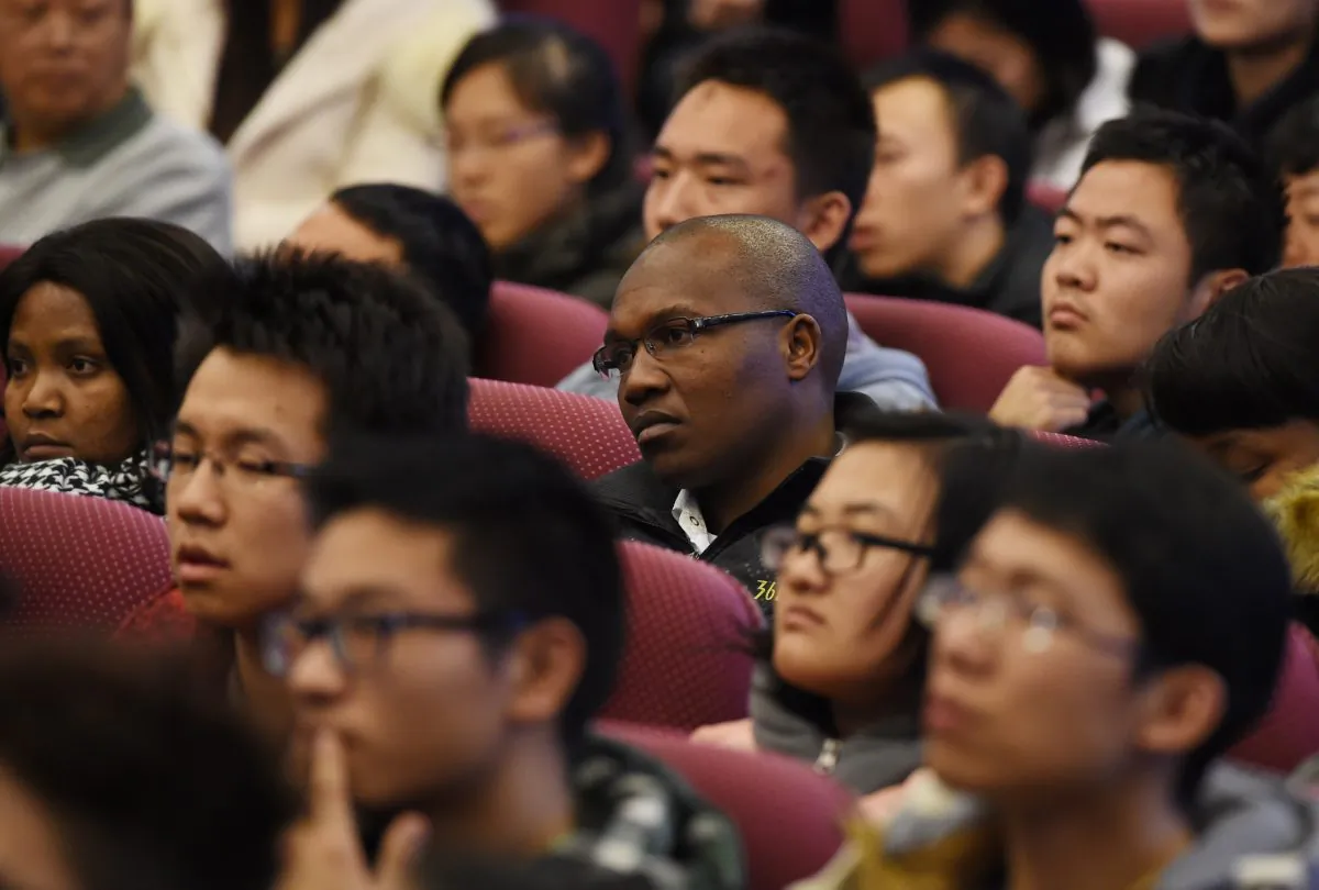 South African and Chinese students listen to a speech by South African President Jacob Zuma at Tsinghua University in Beijing on December 5, 2014. (GREG BAKER/AFP/Getty Images)