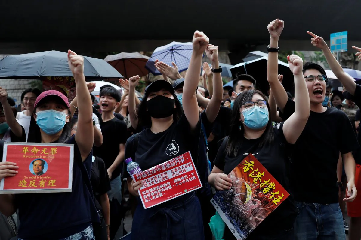 Anti-extradition bill protesters shout slogans to Chinese tourists during a march to West Kowloon Express Rail Link Station in Hong Kong, China on July 7, 2019. (Tyrone Siu/Reuters)