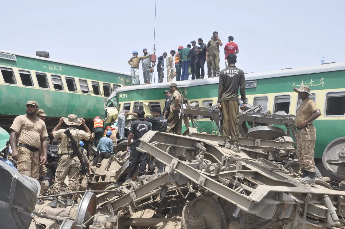 Pakistani officials and volunteers work at a train crash site in Rahim Yar Khan, Pakistan on July 11, 2019. (Waleed Saddique/AP)
