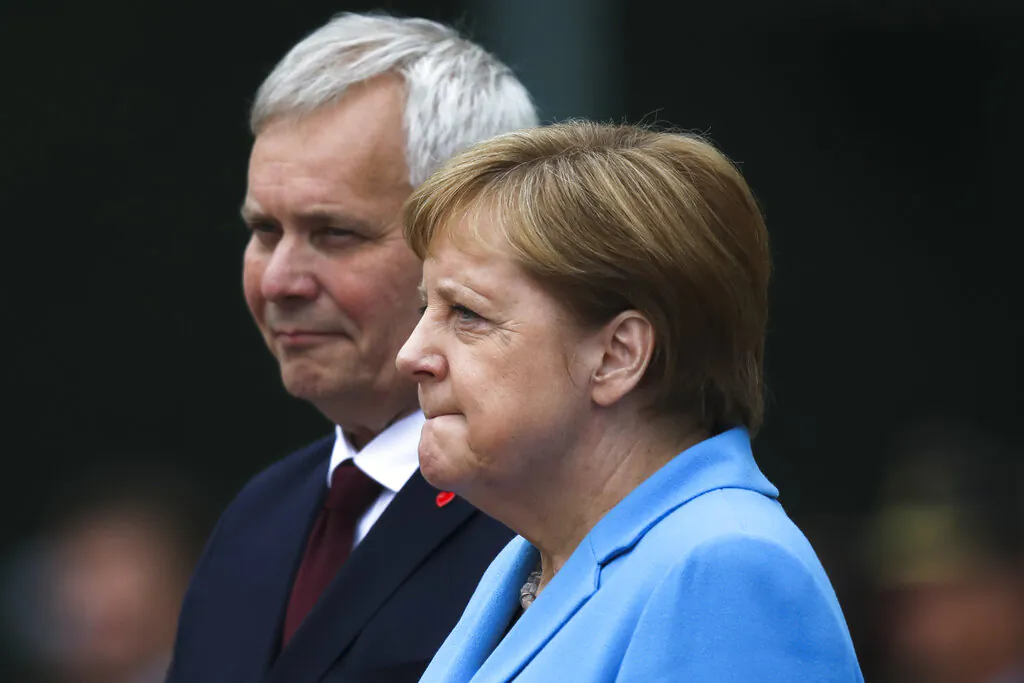 German Chancellor Angela Merkel and Prime Minister of Finland Antti Rinne listen to the national anthems during the welcoming ceremony at the chancellery in Berlin, Germany, on July 10, 2019. (Markus Schreiber/AP Photo)