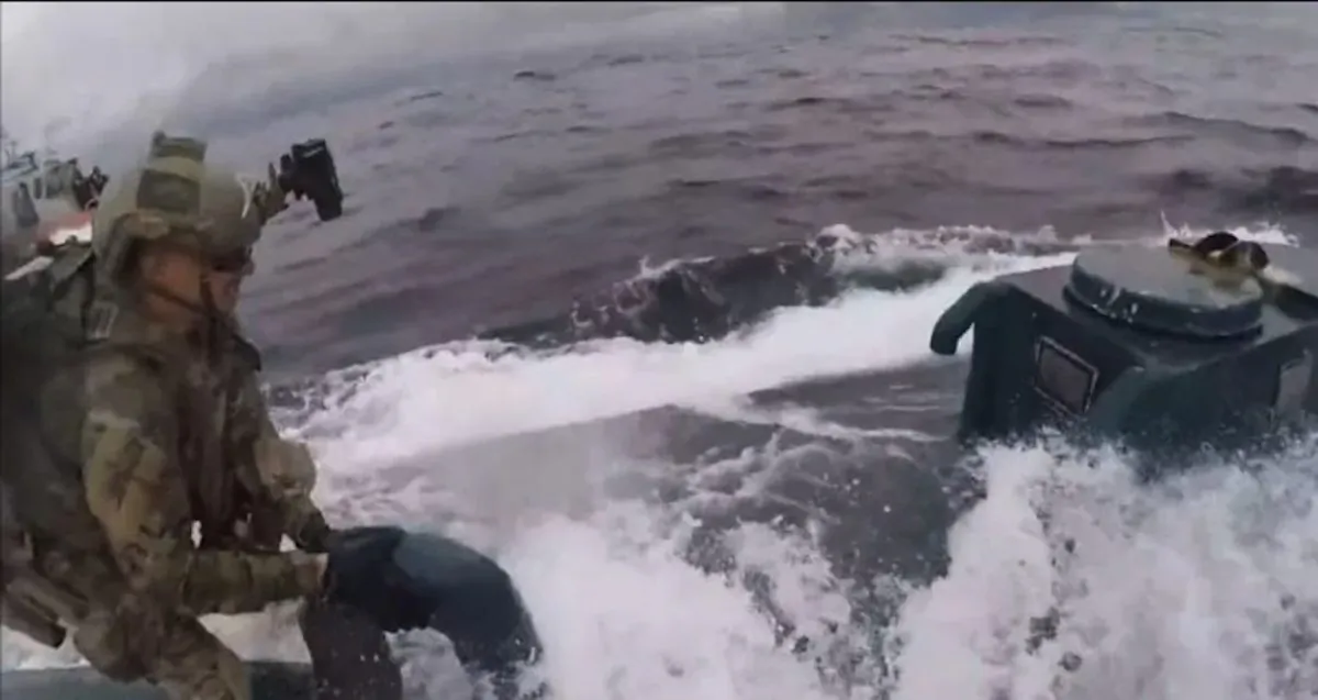 A U.S. Coast Guard member boards a suspected "narco sub" in the international waters of the Eastern Pacific Ocean on June 18, 2019. (U.S. Coast Guard)