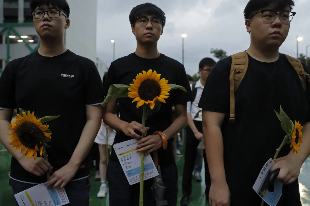 Attendees take part in a public memorial for Marco Leung, a 35-year-old man who fell to his death weeks ago after hanging a protest banner against an extradition bill, in Hong Kong, China on July 11, 2019. The parents of Leung have urged young people to stay alive to continue their struggle. (Kin Cheung/AP)