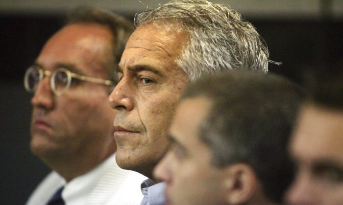In this July 30, 2008, file photo, Jeffrey Epstein, center, appears in court in West Palm Beach, Fla. (Uma Sanghvi/Palm Beach Post via AP, File)